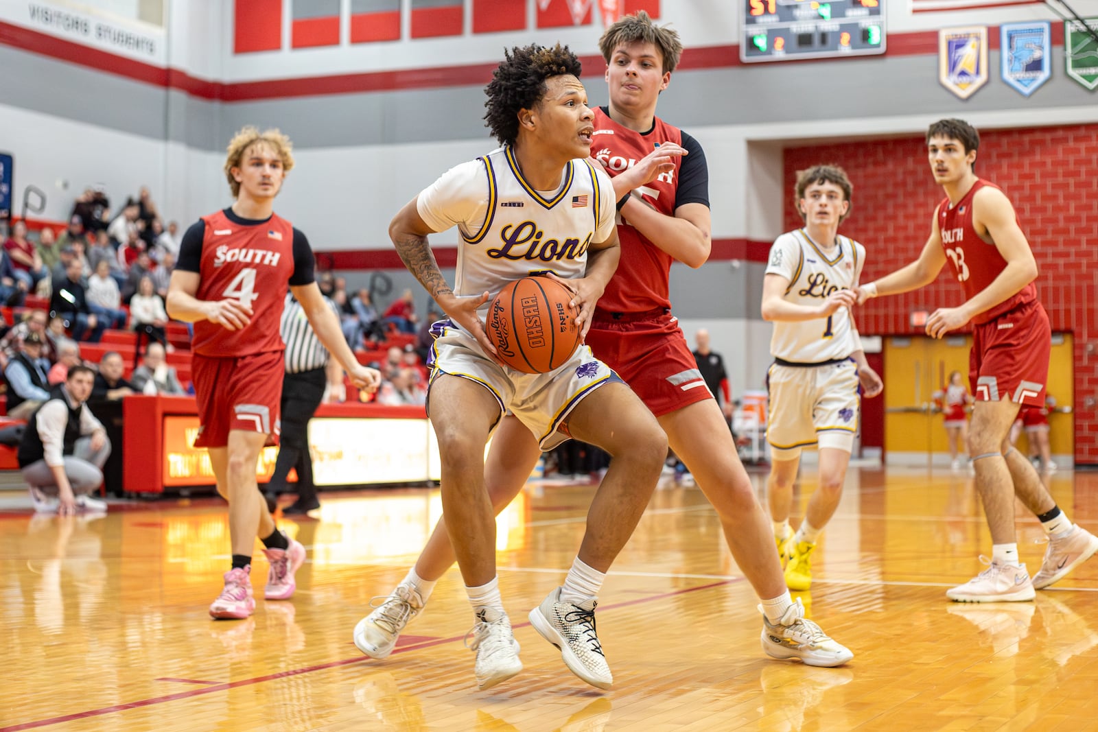Emmanuel Christian Academy junior Jayden Thomas drives past Twin Valley South junior Trent Ray during their Division VI district semifinal game on Monday, March 2, 2026 at Troy High School. The Lions won 73-50. MICHAEL COOPER / STAFF