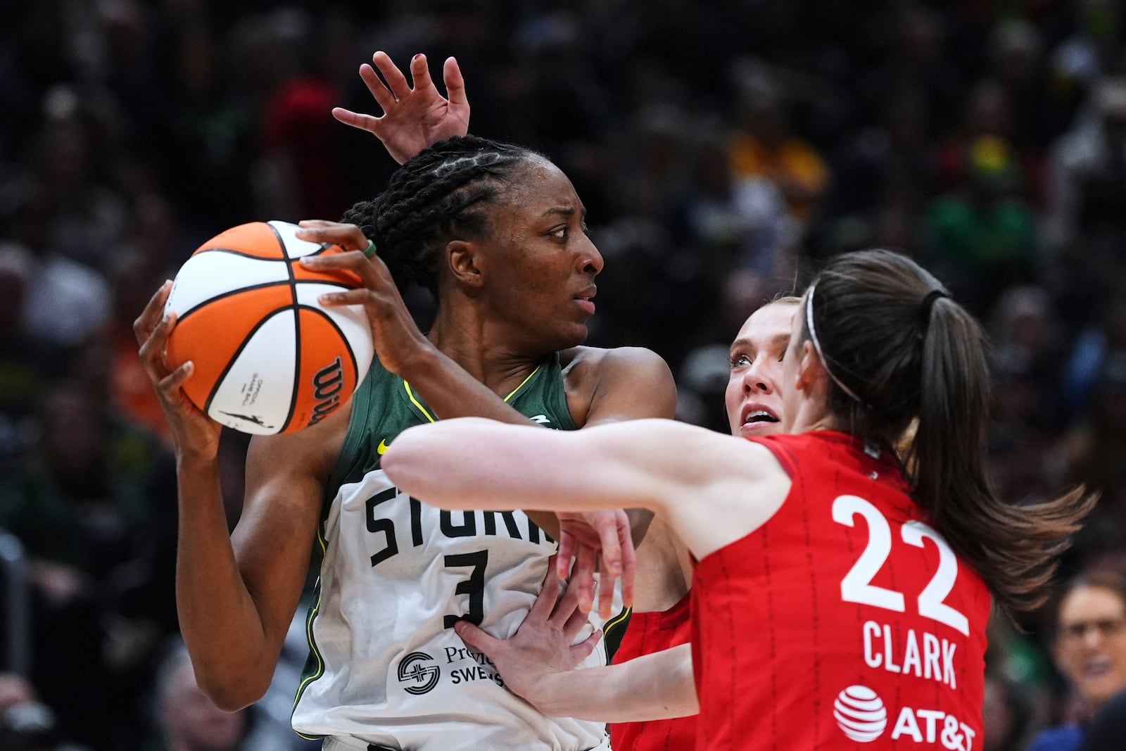 Seattle Storm forward Nneka Ogwumike, left, tries to look around the defense from Indiana Fever guard Lexie Hull, back and guard Caitlin Clark, right, during the second half of a WNBA basketball game Tuesday, June 24, 2025, in Seattle. (AP Photo/Lindsey Wasson)