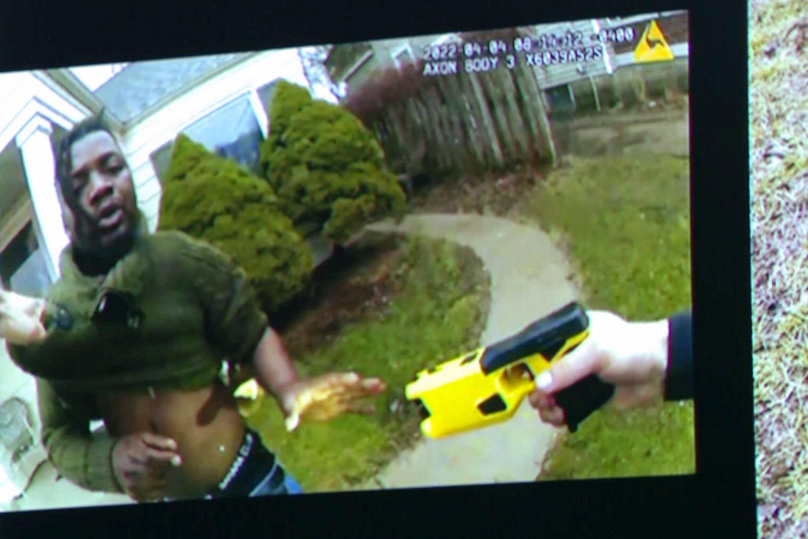 Body worn camera footage showing former Grand Rapids Police officer Christopher Schurr with a Taser7 and Patrick Lyoya is shown during the third day at the Kent County Courthouse with his wife Brandey in Grand Rapids, Mich. on Wednesday, April 30, 2025. (Joel Bissell/Kalamazoo Gazette via AP)