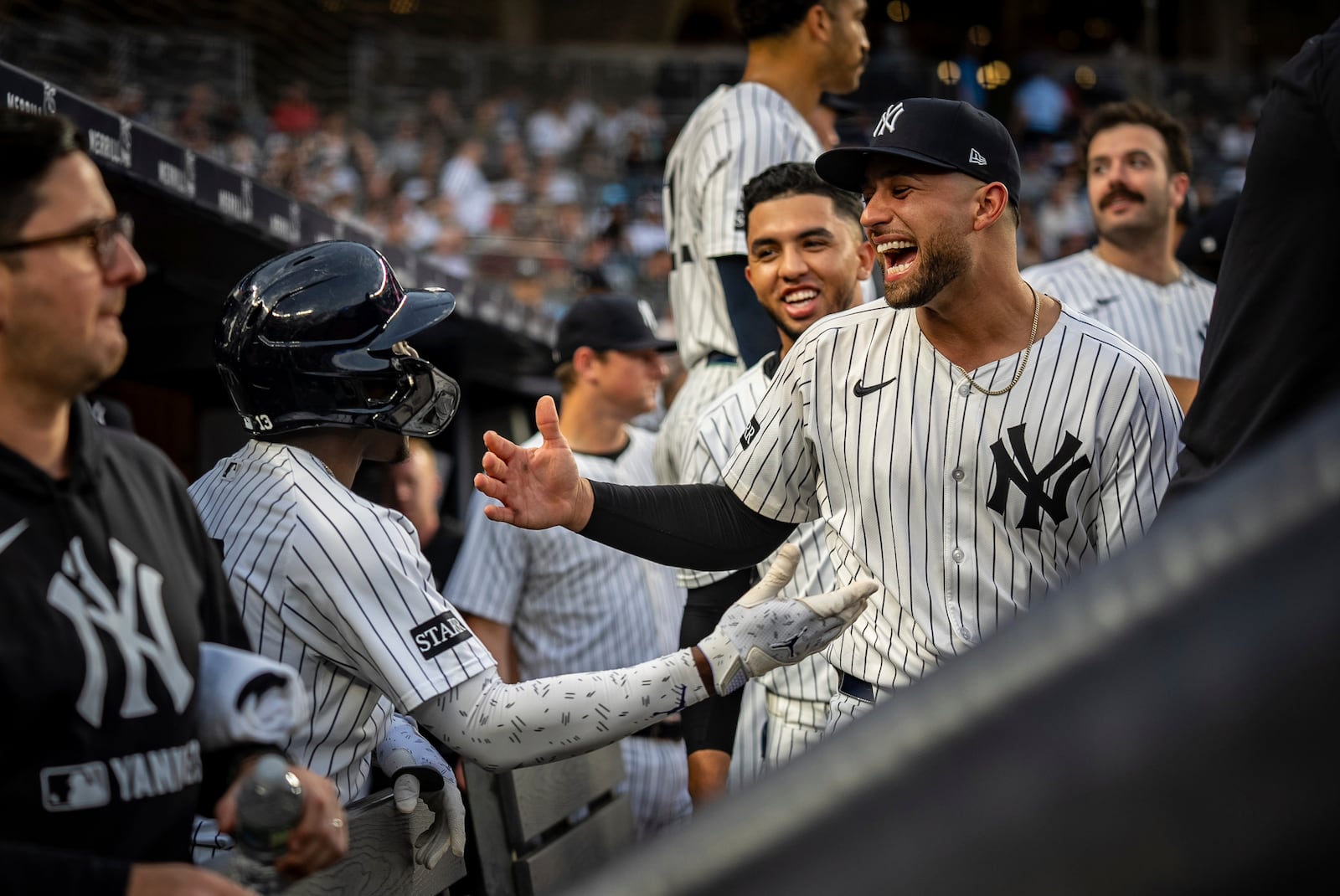 New York Yankees catcher J.C. Escarra (25) congratulates Jazz Chisholm Jr. (13) on his home run during the second inning of a baseball game against the Los Angeles Angels, Wednesday, June 18, 2025, in New York. (AP Photo/Angelina Katsanis)
