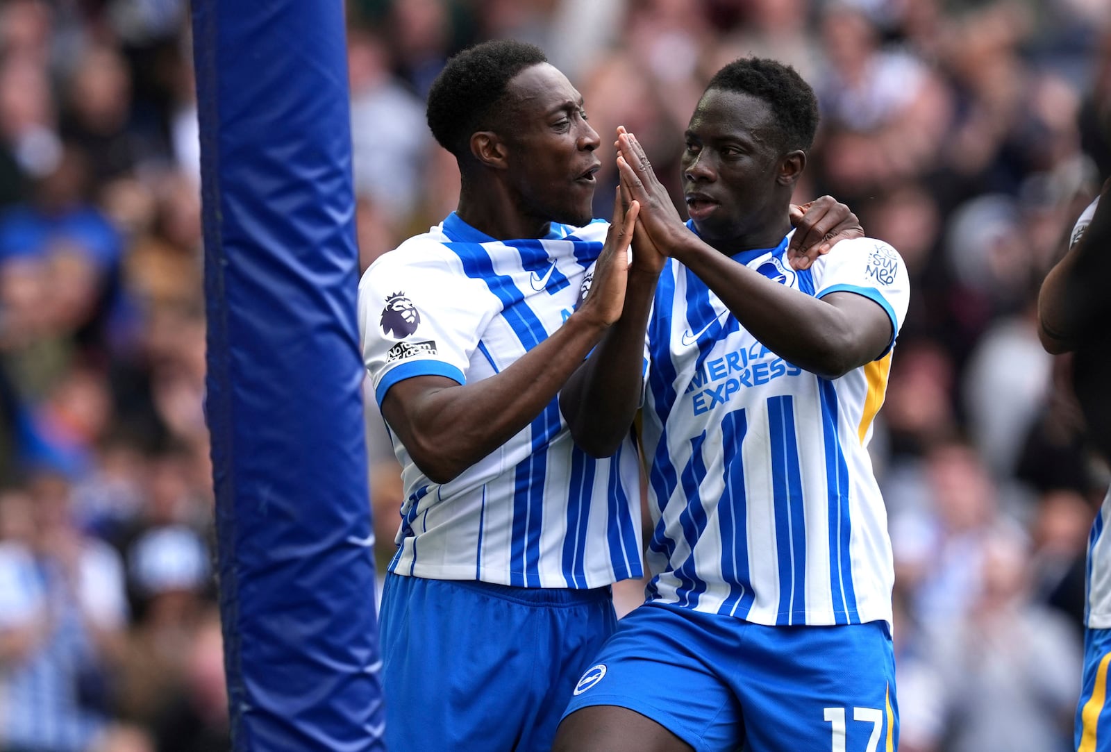 Brighton and Hove Albion's Yankuba Minteh, right, celebrates with Danny Welbeckduring after scoring the opening goal during the English Premier League soccer match between Brighton and Hove Albion and Newcastle United in Brighton and Hove, England, Sunday, May 4, 2025. (Gareth Fuller/PA via AP)