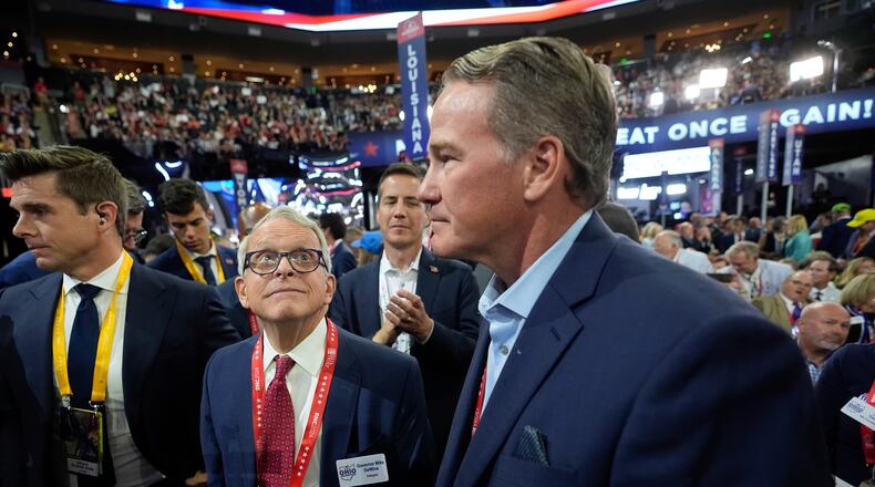 Ohio Gov. Mike DeWine and Lieutenant Gov. Jon Husted react during the Republican National Convention Monday, July 15, 2024, in Milwaukee. (AP Photo/Paul Sancya)