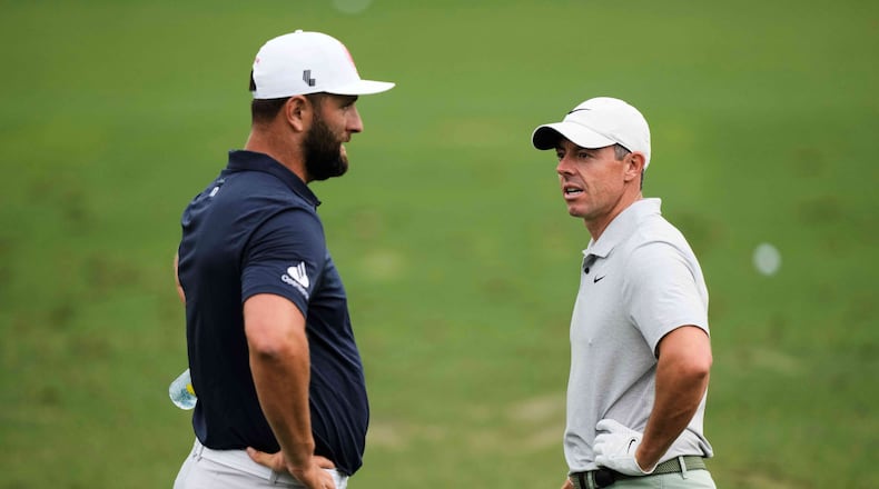 FILE - Jon Rahm, left, of Spain, talks with Rory McIlroy, of Northern Ireland, on the practice range during a practice round in preparation for the Masters golf tournament at Augusta National Golf Club Tuesday, April 9, 2024, in Augusta, Ga. (AP Photo/Charlie Riedel, File)