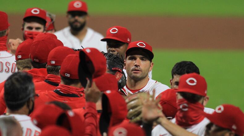 The Reds celebrate a victory against the Indians on Monday, Aug. 3, 2020, at Great American Ball Park in Cincinnati. David Jablonski/Staff