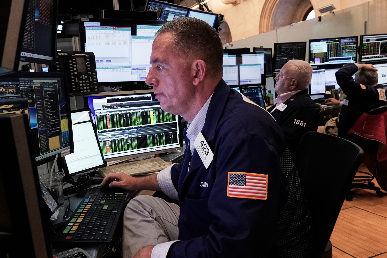 Trader Justin Flinn, left, works on the floor of the New York Stock Exchange, Friday, June 27, 2025. (AP Photo/Richard Drew)