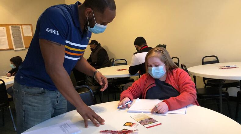 James Cooper works with sixth grader Jeremiah Underwood during a meeting of the "Brake the Cycle" program, a nonprofit group for young men. Photo by Brett Turner