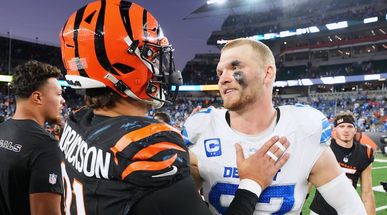 Cincinnati Bengals defensive end Trey Hendrickson (91) and Detroit Lions defensive end Aidan Hutchinson (97) talk after an NFL football game Sunday, Oct. 5, 2025, in Cincinnati. (AP Photo/Jeff Dean)