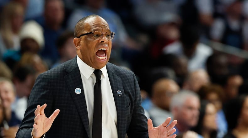 North Carolina head coach Hubert Davis directs his team during the first half of an NCAA college basketball game against Clemson in the quarterfinals of the Atlantic Coast Conference tournament in Charlotte, N.C., Thursday, March 12, 2026. (AP Photo/Nell Redmond)