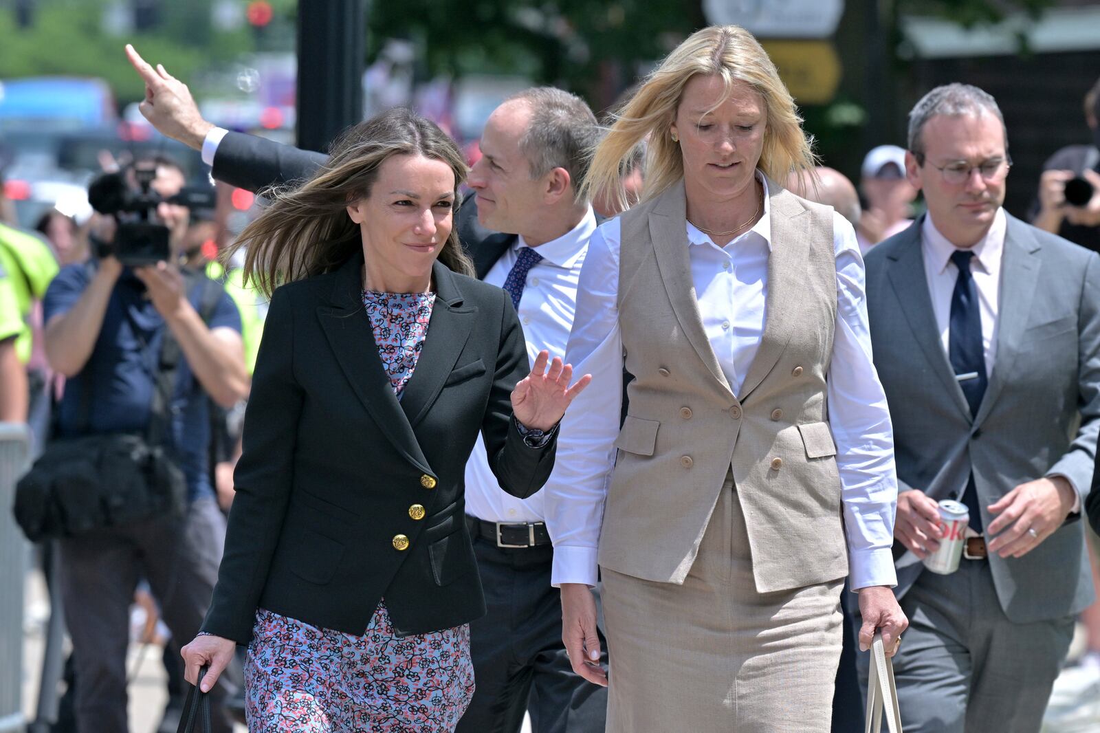 Karen Read, left, and her lawyer David Yanetti, second from left, acknowledge supporters as they return to the Dedham, Mass. courthouse, where the judge was to issue instructions to the jury in Read's trial at Norfolk Superior Court, Friday, June 13, 2025, in Dedham, Mass. (AP Photo/Josh Reynolds)