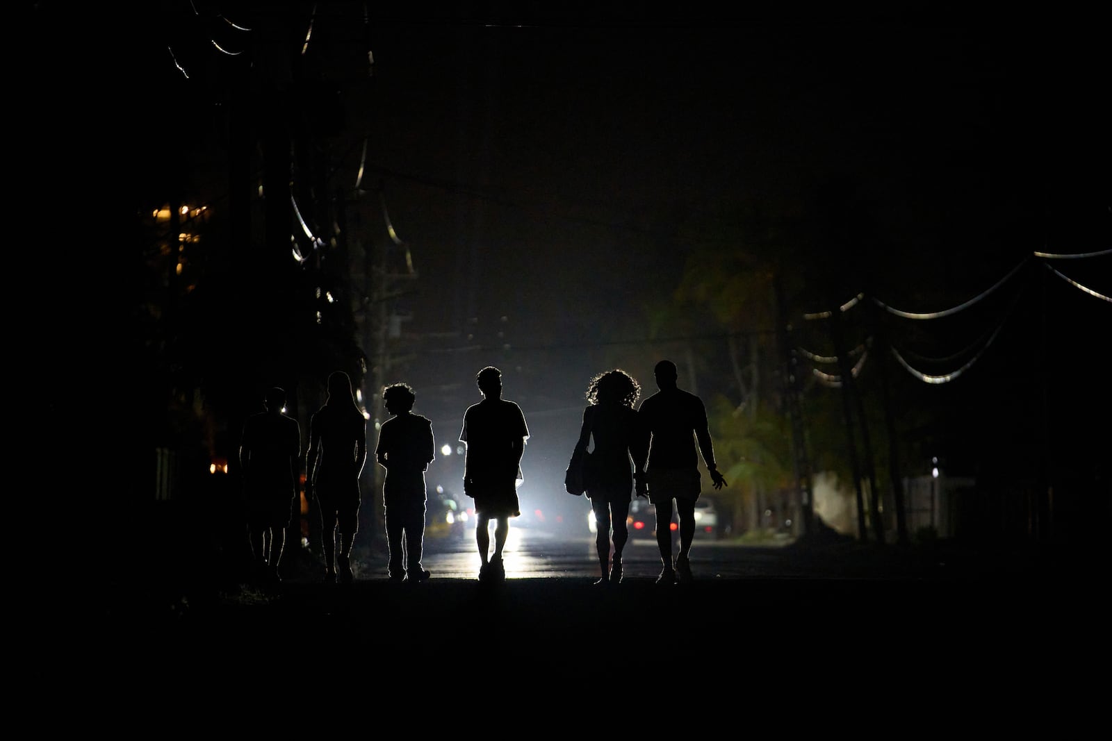 People walk in the dark during a blackout in Havana, Cuba, Wednesday, May 28, 2025. (AP Photo/Ramon Espinosa)