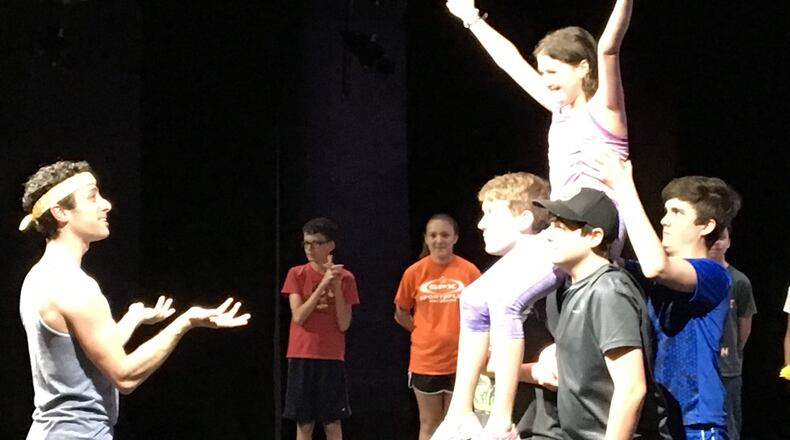 Choreographer Paul Smith (left) gives feedback to Evie Oehlers as Annie (with arms raised) and the ensemble during Monday’s rehearsal for the Youth Arts’ Ambassadors’ musical production of “Annie, Jr.” CONTRIBUTED