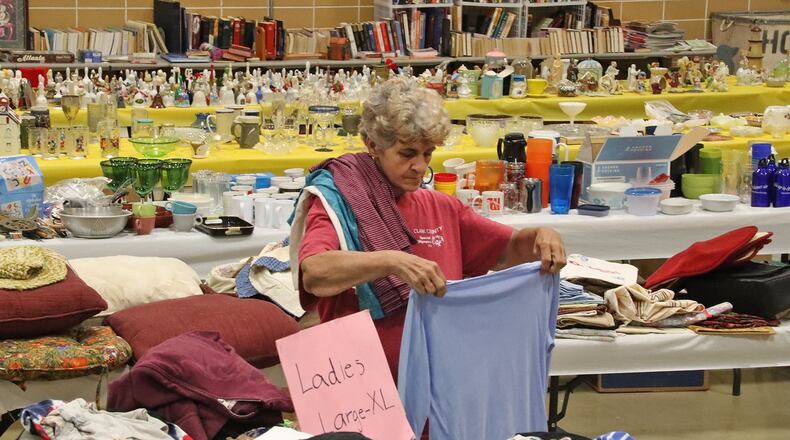 Denise Skaggs folds clothing at the Special Olympics Garage Sale at the FF Mueller campus, 2535 Kenton Street. The salek, which runs through Saturday, helps pay for Special Olympians in Clark County to go to the Special Olympics in Columbus. BILL LACKEY/STAFF