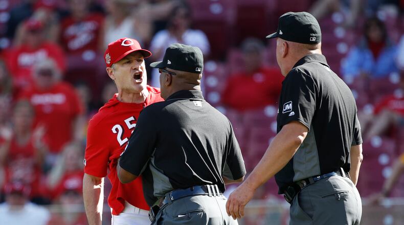 CINCINNATI, OH - MAY 29: Cincinnati Reds manager David Bell #25 is restrained by first base umpire Laz Diaz after being ejected from the game by crew chief Jeff Nelson in the eighth inning of a game against the Pittsburgh Pirates at Great American Ball Park on May 29, 2019 in Cincinnati, Ohio. The Pirates won 7-2. (Photo by Joe Robbins/Getty Images)