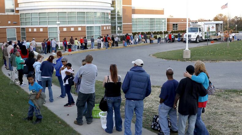 A line of people waiting for the Mobile Food Pantry wraps around part of the parking lot at Clark School Friday. Bill Lackey/Staff