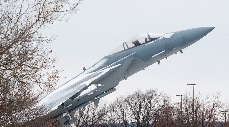 Snow frosts the wings and canopy of an F-15 Eagle on static display in from of the Air Force Materiel Command headquarters building on Wright-Patterson Air Force Base Dec. 1. U.S. AIR FORCE PHOTO/R.J. ORIEZ