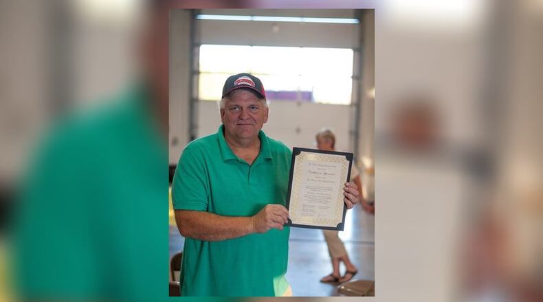 Scott Suther holds a Certificate of Appreciation for the Medway Historical Society from the Bethel Township Trustees. (Photo from his Facebook Page)