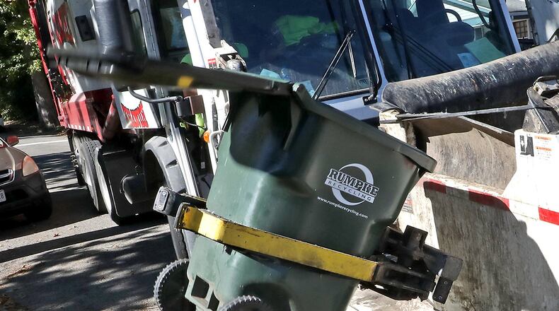 A Rumpke recycling truck grabs a recycling toter and flips it upside down as it collects recycling Thursday in Urbana. Urbana residents recycle so much their hauler is making changes to keep up with the amount of material being collected. Beginning the week of Nov. 1, Rumpke will add days to its collection in order to more efficiently keep up with the amount of material being left on the curb by residents, said Doug Crabill, community development manager for Urbana. BILL LACKEY/STAFF