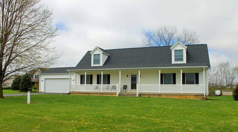 This 3-bedroom home with about 2,460 sq. ft. of living space offers a covered front porch for outdoor enjoyment. CONTRIBUTED PHOTO BY VICKIE KAPNAS