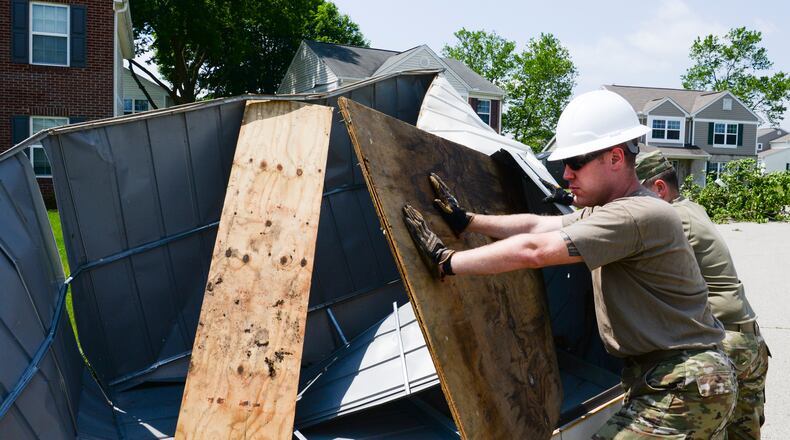 Staff Sgt. Michael Olson, National Air and Space Intelligence Center, helps to remove a shed from the front yard of someone’s home during recovery operations. Residents worked alongside other volunteers from around Wright-Patterson AFB and base emergency responders to ensure everyone’s safety and begin the cleanup process. (U.S. Air Force photo by R.J. Oriez)