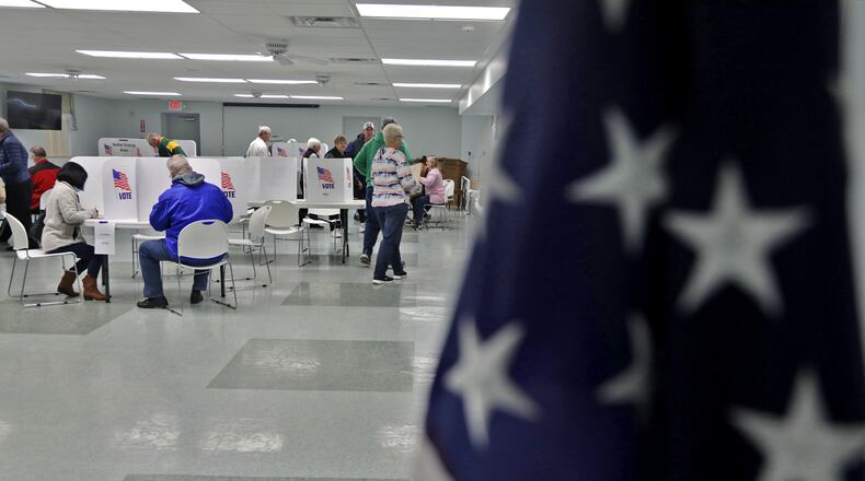 Voters fill out their ballots Tuesday at Enon Knob Prairie United Church in Mad River Township. BILL LACKEY/STAFF