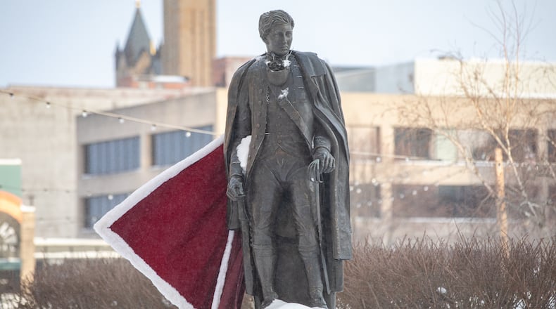 A cape affixed to the statue of George Rogers Clark blows in the wind on Tuesday, Jan. 27 in downtown Springfield. The city received 13 inches of snow over the weekend. BRYANT BILLING / STAFF