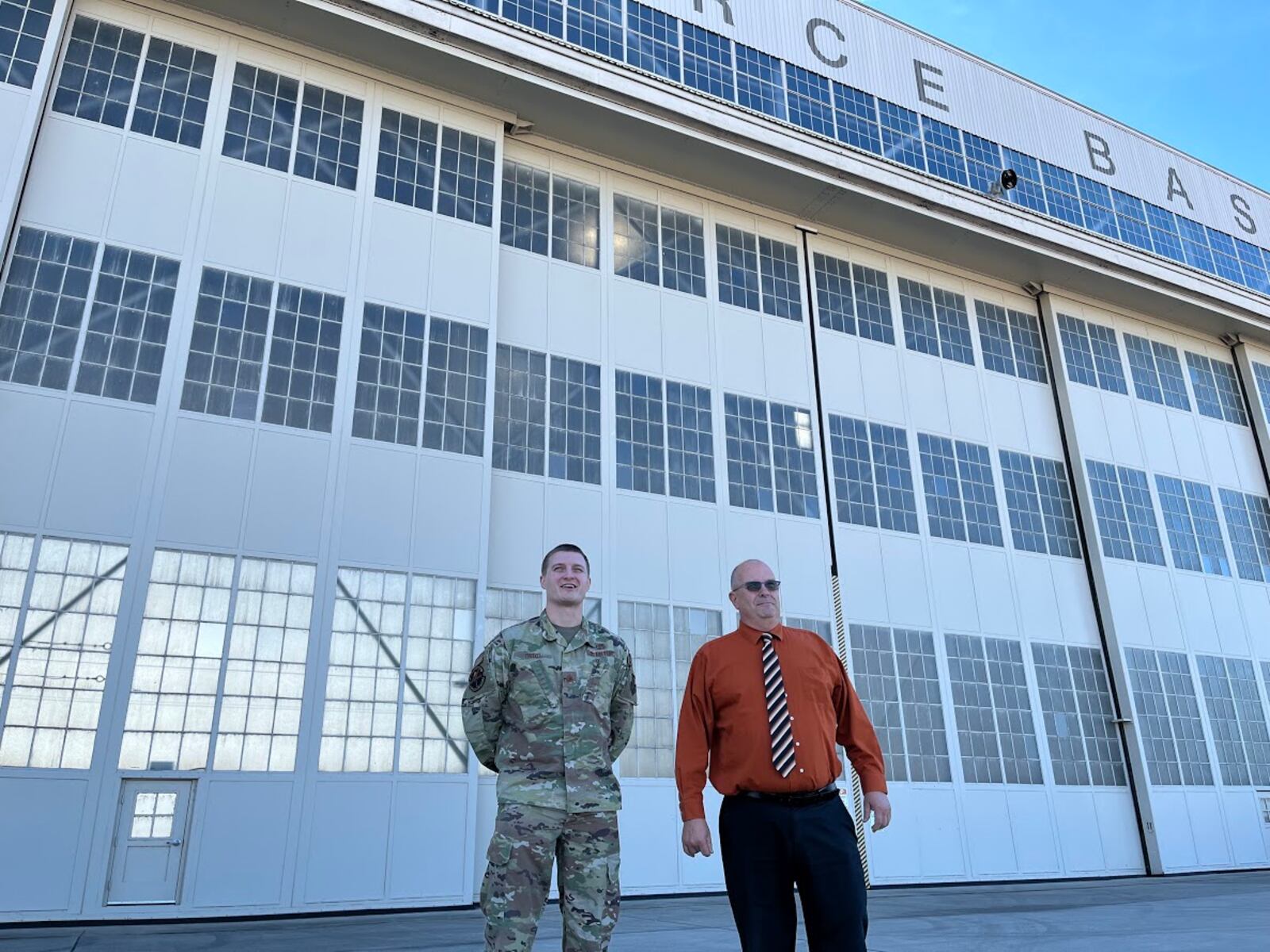 Maj. Hollis Troxel, director of operations for the 88th Operations Support Squadron at Wright-Patterson Air Force Base (left), and Thomas Riste, director 88th Logistics Readiness Squadron, also at Wright-Patt, on the base flight line Tuesday. THOMAS GNAU/STAFF 