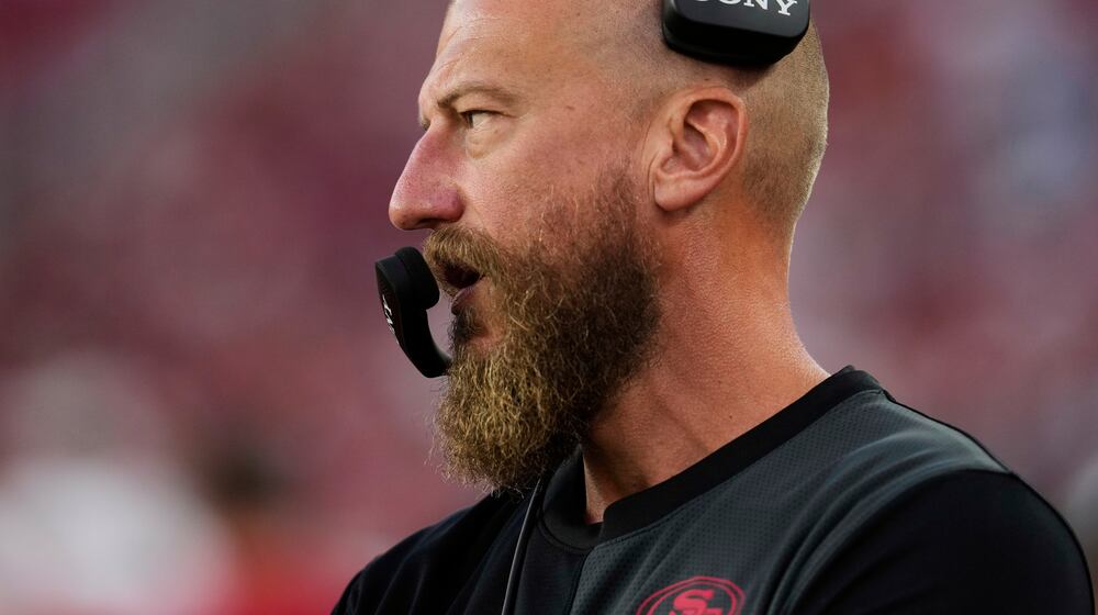 FILE - San Francisco 49ers run game coordinator/tight ends coach Brian Fleury, now offensive coordinator for the Seattle Seahawks, watches from the sideline during the second half of an NFL preseason football game against the Los Angeles Chargers, Aug. 23, 2025, in Santa Clara, Calif. (AP Photo/Godofredo A. Vásquez, File)