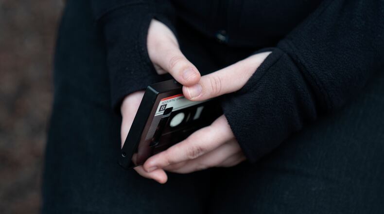 Amelia, 16, holds her phone as she sits for a portrait in a park near her home in Illinois, on Friday, March 24, 2023. She had depression that was exacerbated during the pandemic and received help at a children's hospital. “We are trying to survive in a world that is out to get us," Amelia says. (AP Photo Erin Hooley)