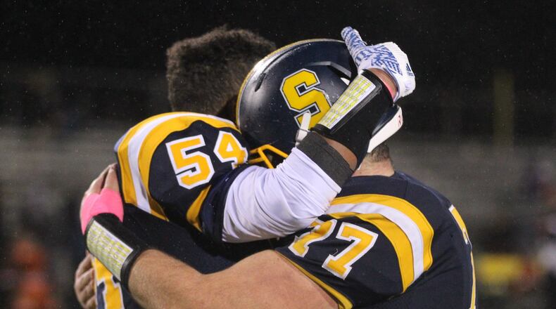 Springfield’s Trey Harper and Alex Temple hug after a victory against Wayne on Friday, Oct. 19, 2018, at Evans Stadium in Springfield. David Jablonski/Staff