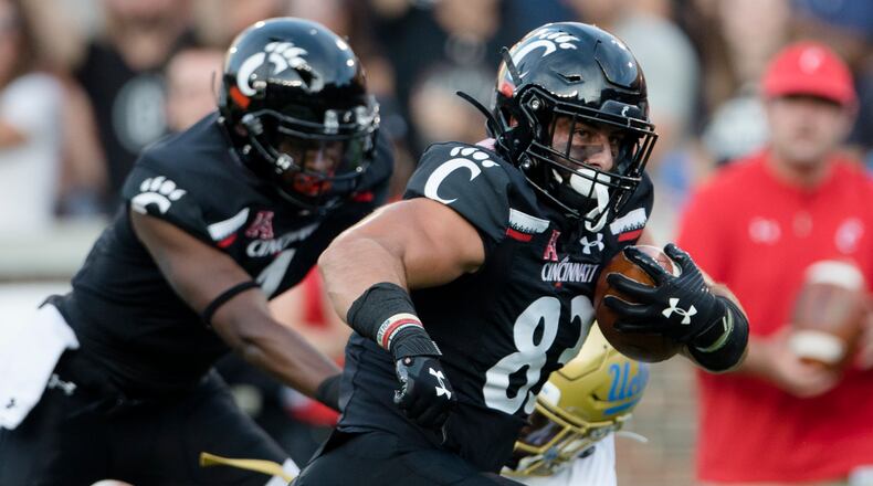 Cincinnati tight end Josiah Deguara (83) scores a touchdown against UCLA during the first half of an NCAA college football game Thursday, Aug. 29, 2019, in Cincinnati. (Albert Cesare/The Cincinnati Enquirer via AP)