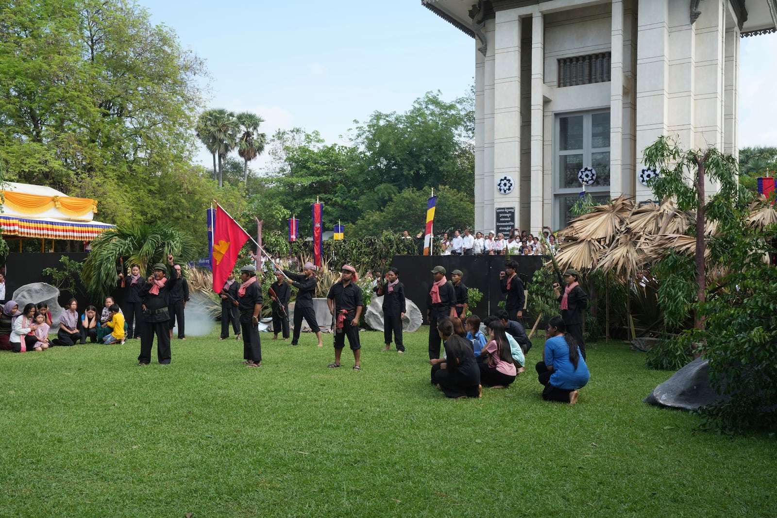 FILE - Cambodian students of Royal University of Fine Arts reenact torture and execution by the Khmer Rouge during their reign of terror in the 1970s, in an event hosted by the ruling Cambodian People's Party to mark the annual Day of Anger at Choeung Ek, a former Khmer Rouge "killing field," on the outskirt of Phnom Penh, Cambodia Wednesday, May 20, 2015. (AP Photo/Heng Sinith, File)