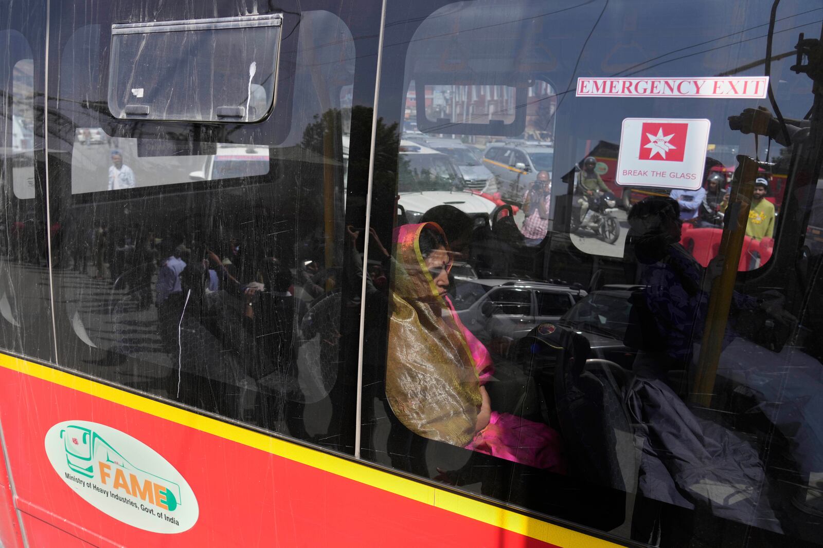 Relatives and friends of killed tourists move in a bus towards the airport in Srinagar, Indian controlled Kashmir, Wednesday, April 23, 2025. (AP Photo/Mukhtar Khan)