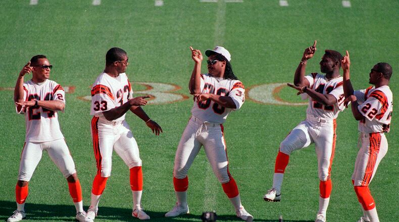 FILE - Cincinnati Bengals fullback Ickey Woods, center, and teammates do their dance for the media, Jan. 17, 1989, at Super Bowl Media Day in Miami. Players from the 1988 Bengals Super Bowl team are reveling the success in the current team, which is playing in the AFC championship game Sunday, Jan. 30, 2022, in Kansas City. (AP Photo/Al Behrman, File)