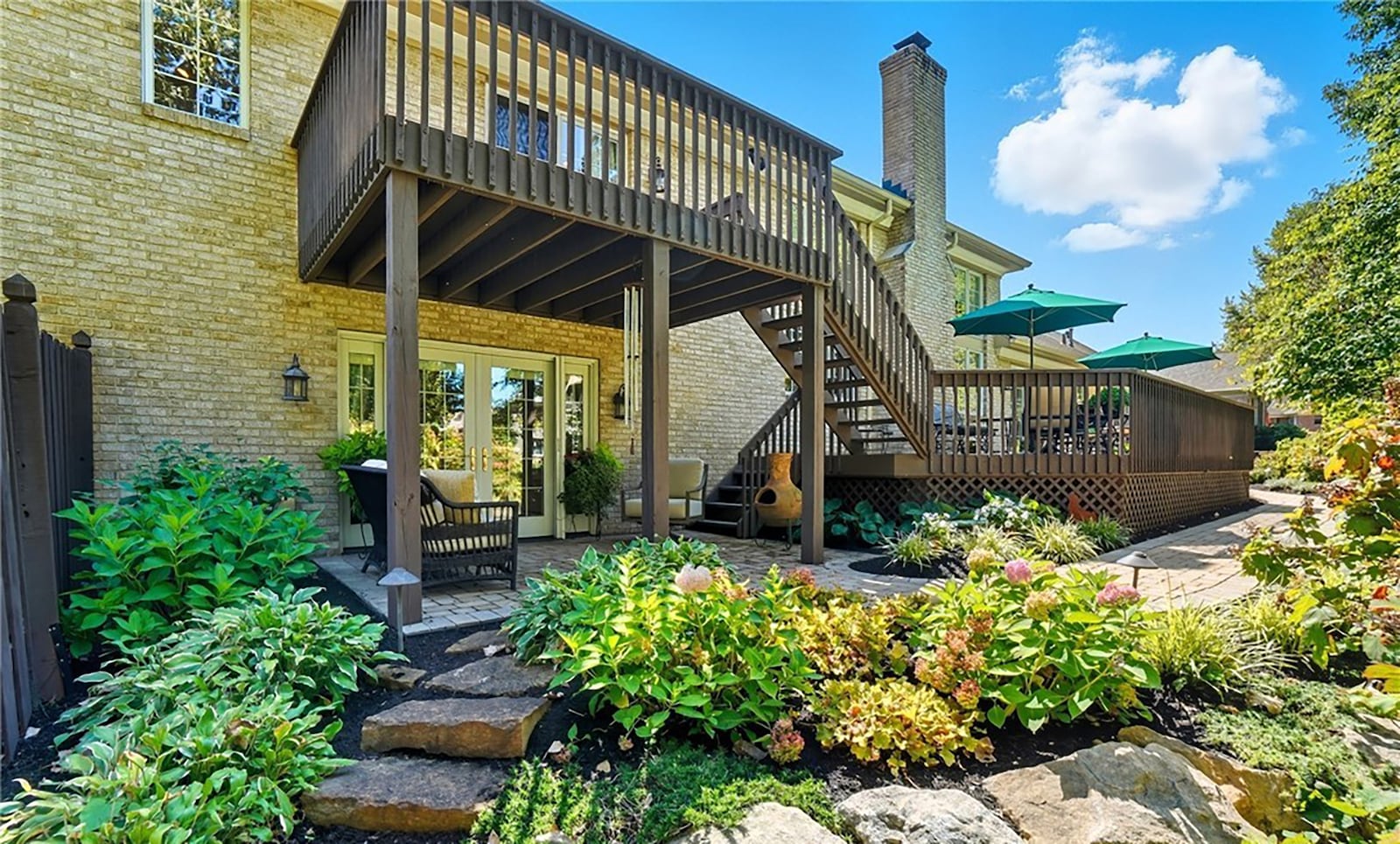 The rear of the home features a multi level wood deck and paver patio off the walk out basement. It is heavily landscaped, fully fenced and has mature trees. CONTRIBUTED