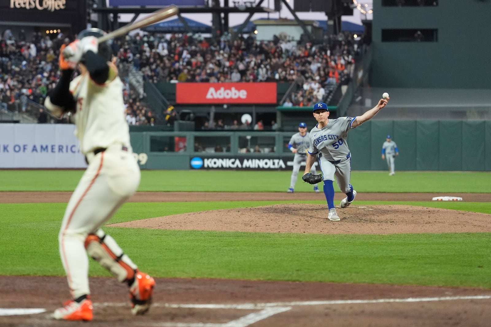 Kansas City Royals pitcher Kris Bubic (50) throws a pitch to San Francisco Giants' Jung Hoo Lee, left, during the sixth inning of a baseball game in San Francisco, Monday, May 19, 2025. (AP Photo/Jeff Chiu)