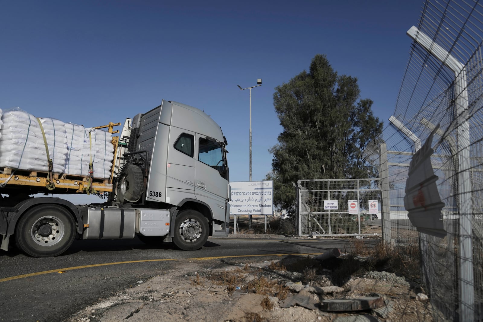 A truck carrying humanitarian aid for the Gaza Strip enters to Kerem Shalom Crossing in southern Israel, Tuesday May 20, 2025. (AP Photo/Maya Alleruzzo)