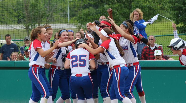 Northwestern sophomore Bry White gets congratulated by her teammates at home after hitting a solo home run in the fifth inning of the Warriors’ 7-0 win against Badin in the Division III regional semifinal on Wednesday at Wright State University. GREG BILLING / CONTRIBUTED