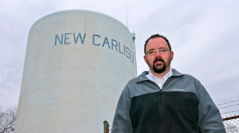 New Carlisle Mayor Mike Lowrey stands under the New Carlisle water tower in 2017. Bill Lackey/Staff