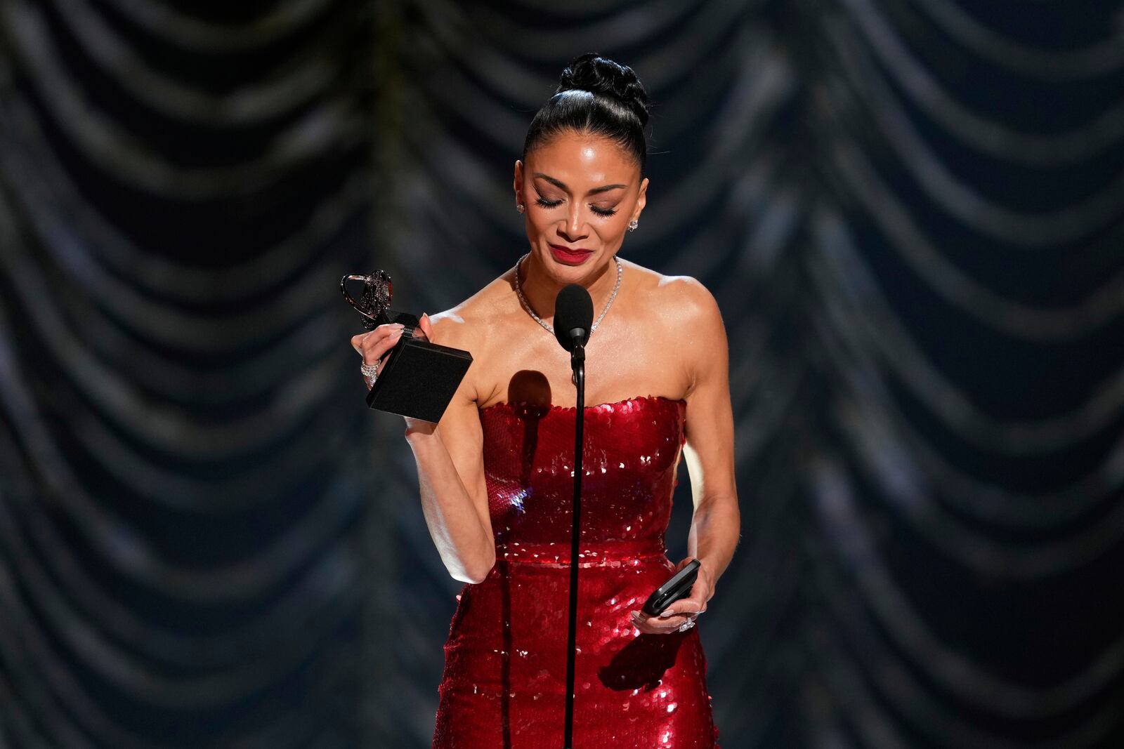 Nicole Scherzinger accepts the award for best performance by an actress in a leading role in a musical for "Sunset Blvd." during the 78th Tony Awards on Sunday, June 8, 2025, at Radio City Music Hall in New York. (Photo by Charles Sykes/Invision/AP)