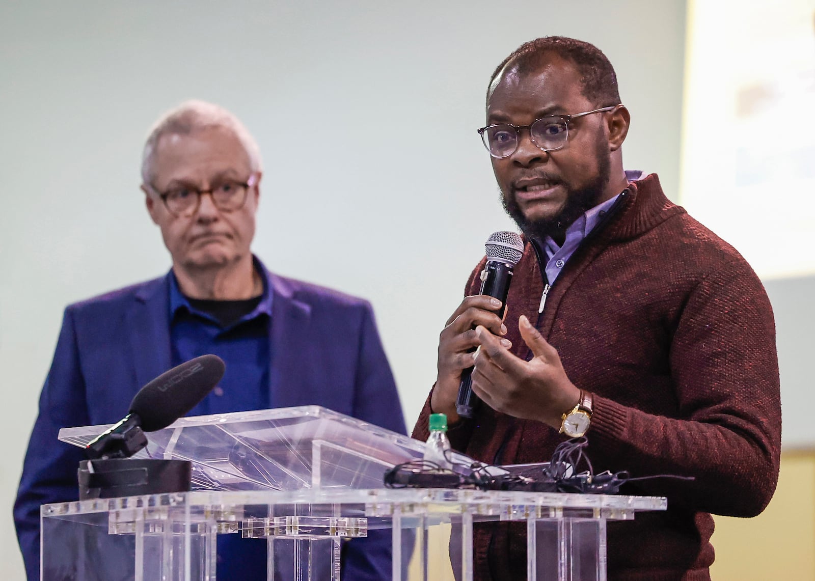 Viles Dorsainvil, right, executive director of the Haitian Support Center, speaks as Carl Ruby, senior pastor at Central Christian Church, listens during a press conference held by Springfield Neighbors United, in partnership with ABLE and G92, at Greater Grace Temple on Monday, March 16, 2026, in Springfield. The press conference was held to ask for support of an amicus brief filed with the U.S. Supreme Court that called for the continuation of Temporary Protected Status for Haitians in Springfield. JOSEPH COOKE/STAFF