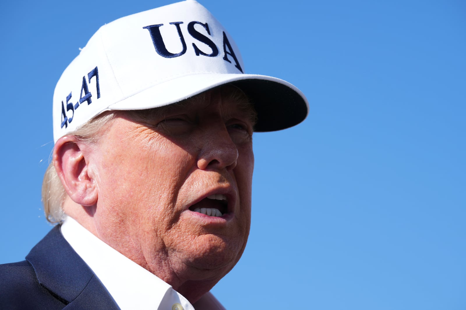 President Donald Trump speaks with reporters before boarding Air Force One at Morristown Municipal Airport in Morristown, N.J., Sunday, July 6, 2025, en route to Washington. (AP Photo/Jacquelyn Martin)