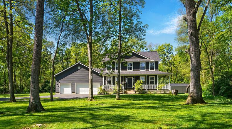 The traditional vinyl sided two story home is on a wooded 1 acre plus lot in South Charleston.