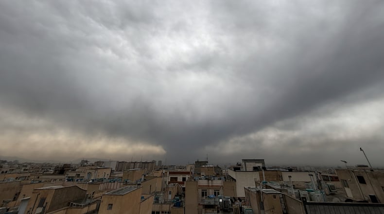 Plumes of smoke from a U.S.-Israeli strike on an oil facility late Saturday linger and merge with the cloudy sky over Tehran, Iran, Sunday, March 8, 2026. (AP Photo/Vahid Salemi)