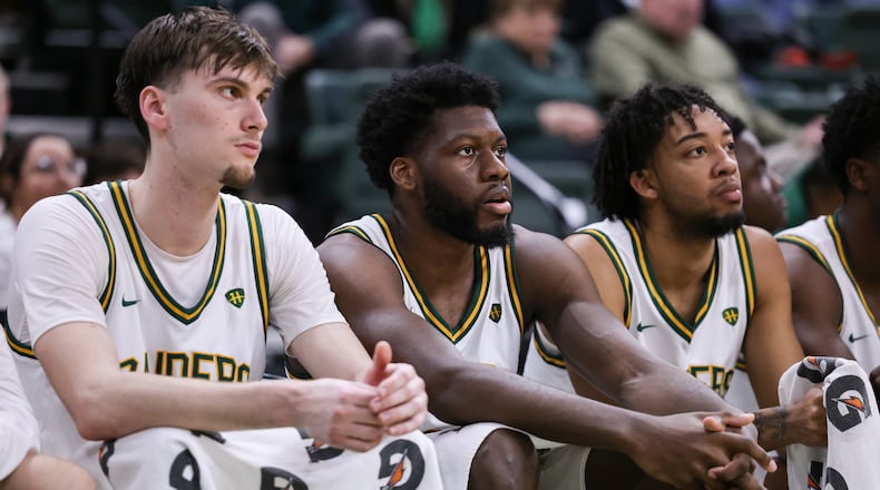 From left to right, Wright State's Kellen Pickett, Michael Imariagbe and Logan Woods watch during from the bench late in a Horizon League Championship first-round game against Cleveland State on Wednesday, March 4 at Ervin J. Nutter Center in Fairborn. BRYANT BILLING / STAFF