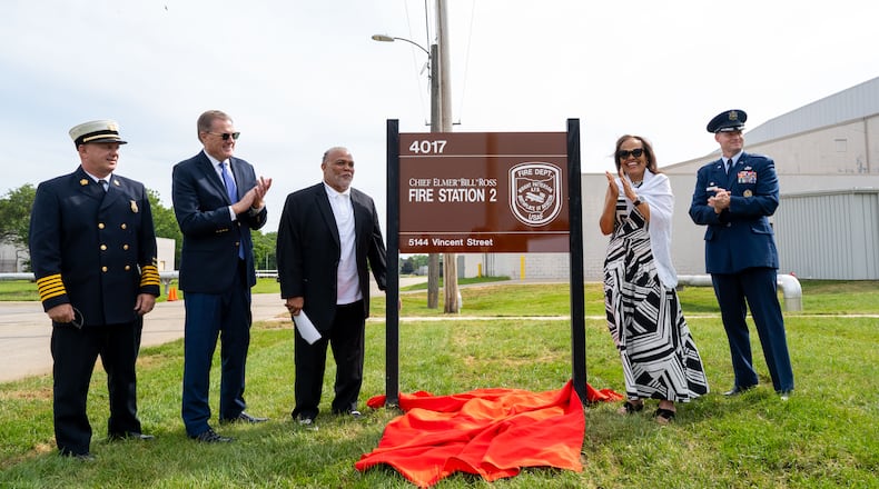 After pulling down the red cloth to reveal the sign announcing the new Elmer “Bill” Ross Fire Station 2 at Wright Patterson Air Force Base, Bill’s son Steve (third from left) accepts a handshake from Congressman Mike Turner as Bill’s daughter Angie manages a smile through what had just been an overflow of tearful emotion. Flanking the group are WPAFB Fire Chief Jeffrey Kitzmiller on the left and Colonel Dustin Richards on the right. WRIGHT-PATT AFB / CONTRIBUTED PHOTO