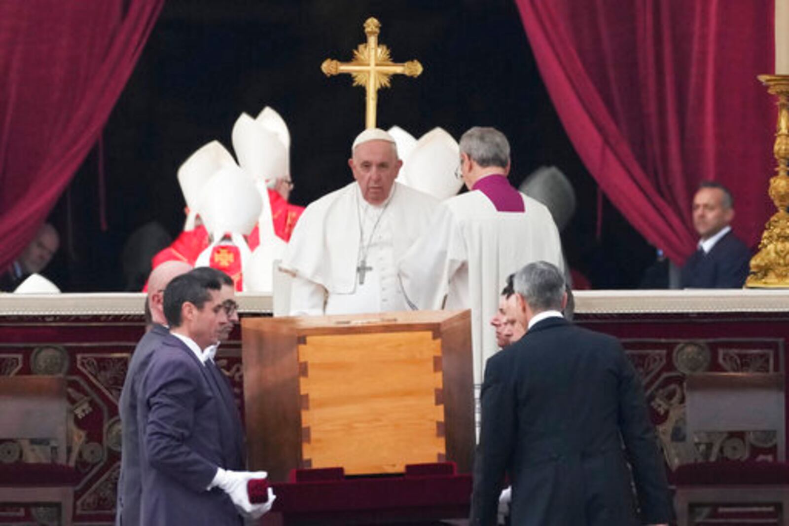 FILE - Pope Francis, center, sits as the coffin of late Pope Emeritus Benedict XVI is carried in St. Peter's Square for his funeral mass, at the Vatican, Thursday, Jan. 5, 2023. (AP Photo/Alessandra Tarantino, File)