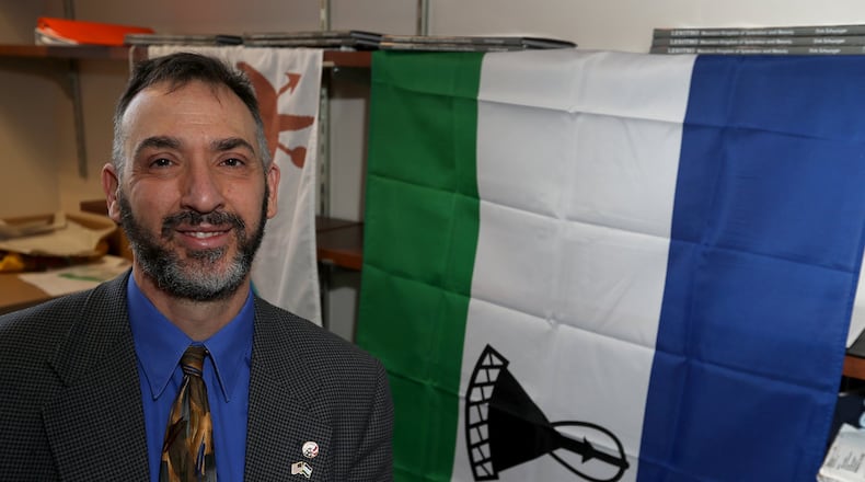 Wittenberg professor, Scott Rosenberg, sits in front of the flag of the African nation of Lesotho Tuesday, Dec. 19, 2017. In May, the king of Lesotho will visit the Wittenberg campus. Bill Lackey/Staff