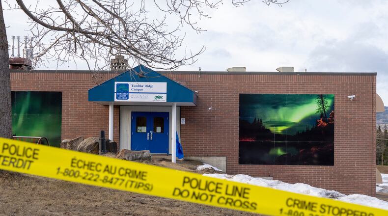 Police tape surrounds a school in Tumbler Ridge, British Columbia, Canada, on Thursday, Feb. 12, 2026, after Tuesday's mass shooting. (Christinne Muschi/The Canadian Press via AP)