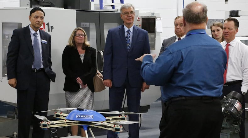 Clark State Community College instructor Larry Everett talk about the school’s precision agriculture program with a tour group, including John Carey, Chancellor of the Ohio Department of Higher Education, center, Wednesday. Bill Lackey/Staff
