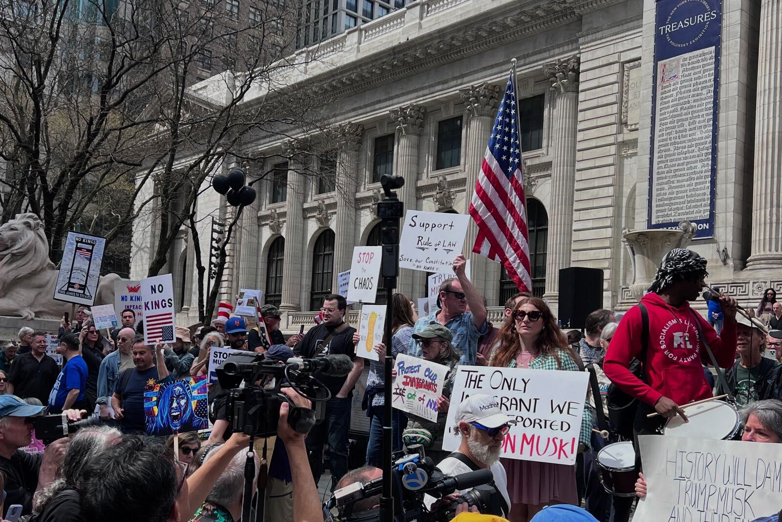People gather to protest President Donald Trump's policies on Saturday, April 19, 2025 in New York. (AP Photo/Joseph Frederick)